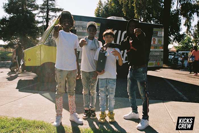 Kids pose with shoes.